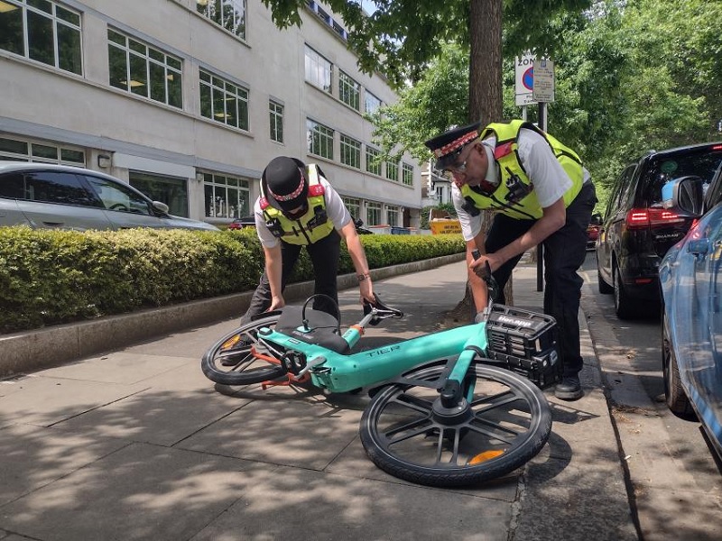 H&F Law Enforcement Team (LET) officers moving a TIER e-bike blocking the pavement
