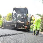 Workers repairing a road surface