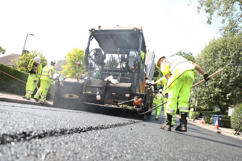 Workers repairing a road surface